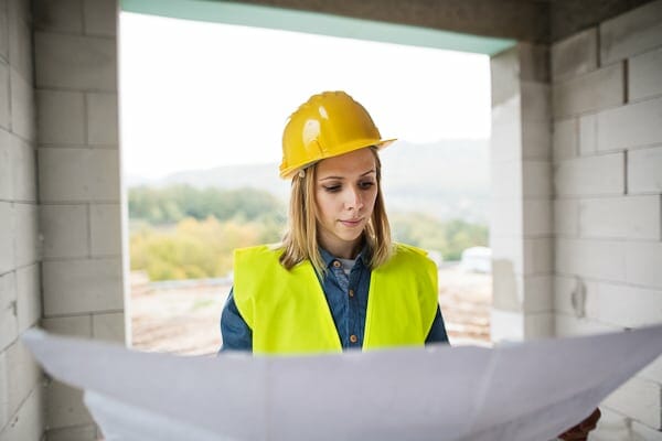 Young woman worker on the building site.